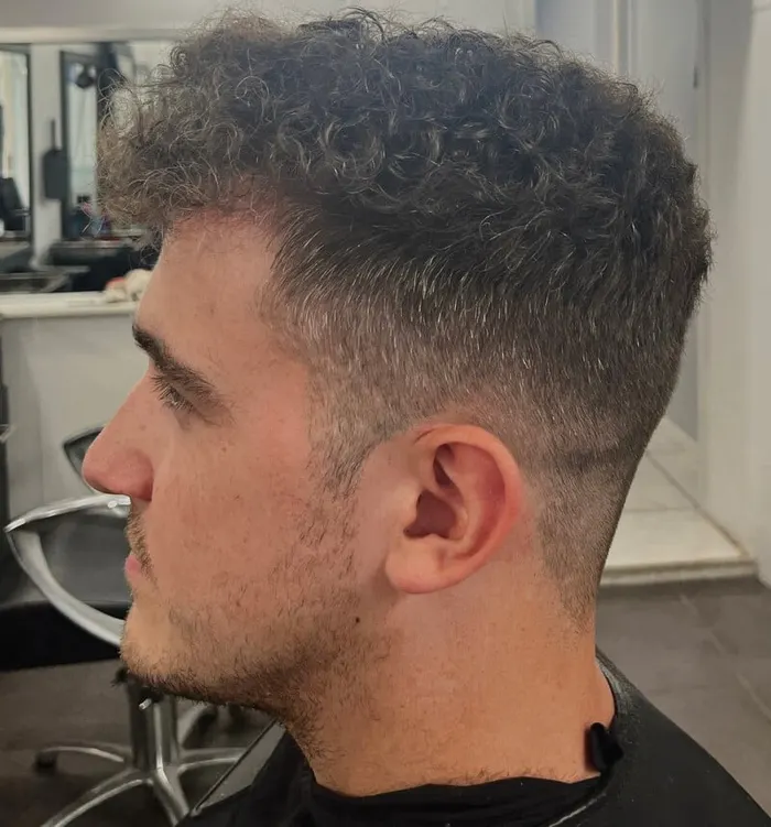 Men's curly top with skin fade barbering at Harvey's Hairdressers, Luton